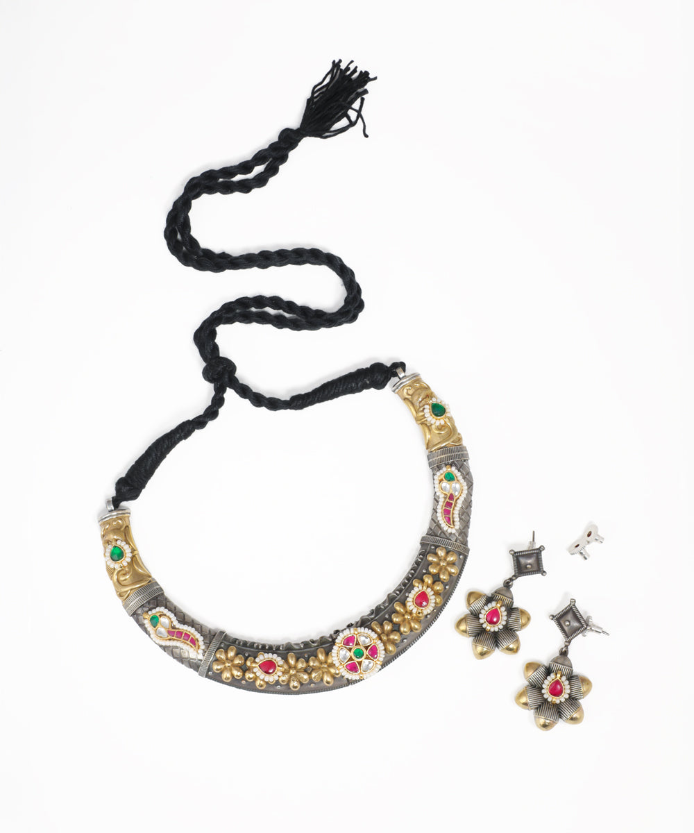 Oxidized silver and gold-tone necklace set with floral design and red, green stones.