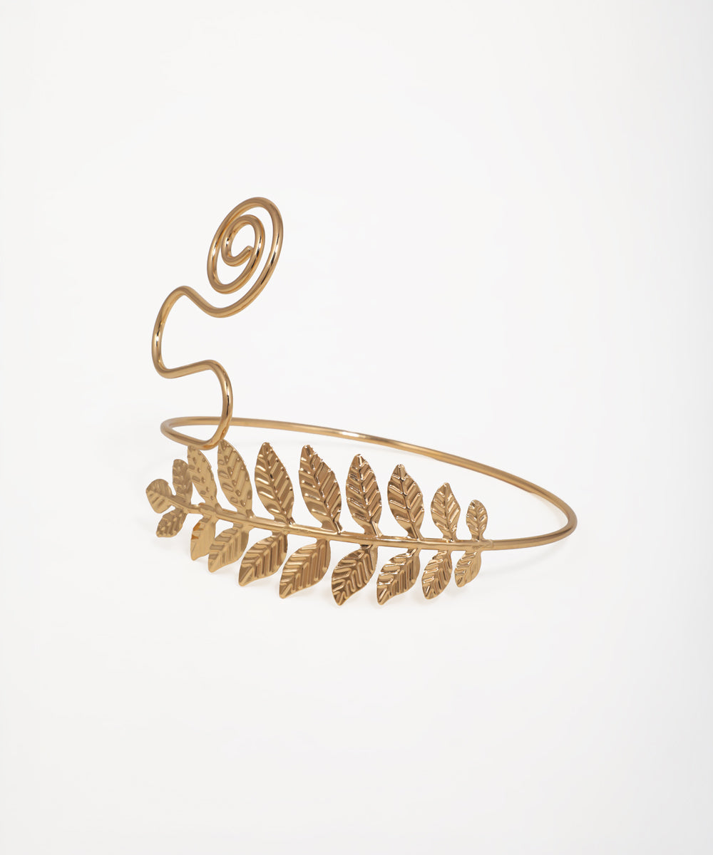 Nature-inspired arm cuff featuring textured leaf motif and spiral detail