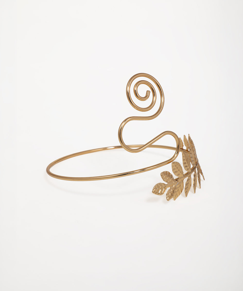 Gold-tone upper arm cuff with laurel leaf branch and sculptural swirl accent
