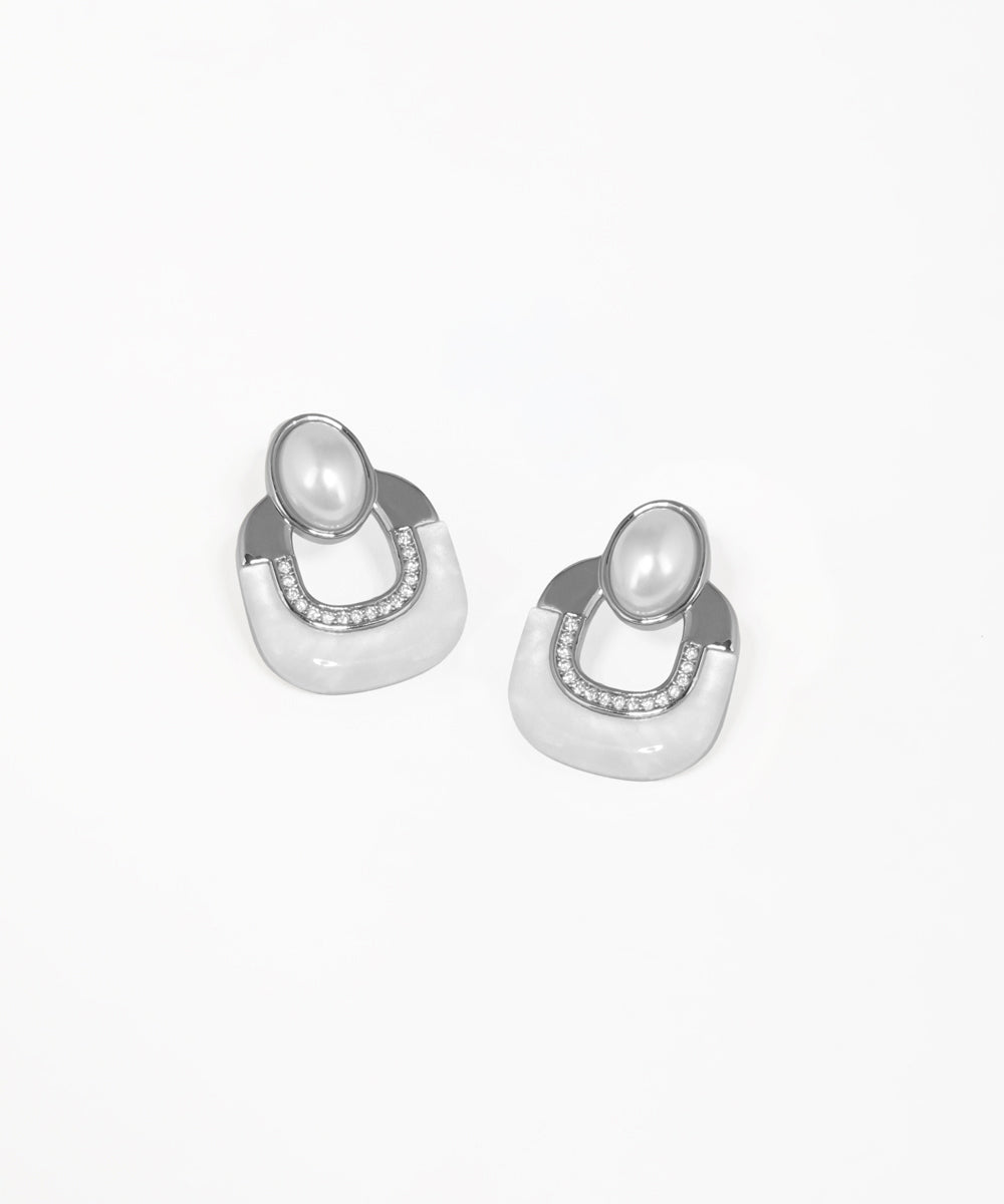 Gold-tone stud earrings featuring an elegant Art Deco arch motif