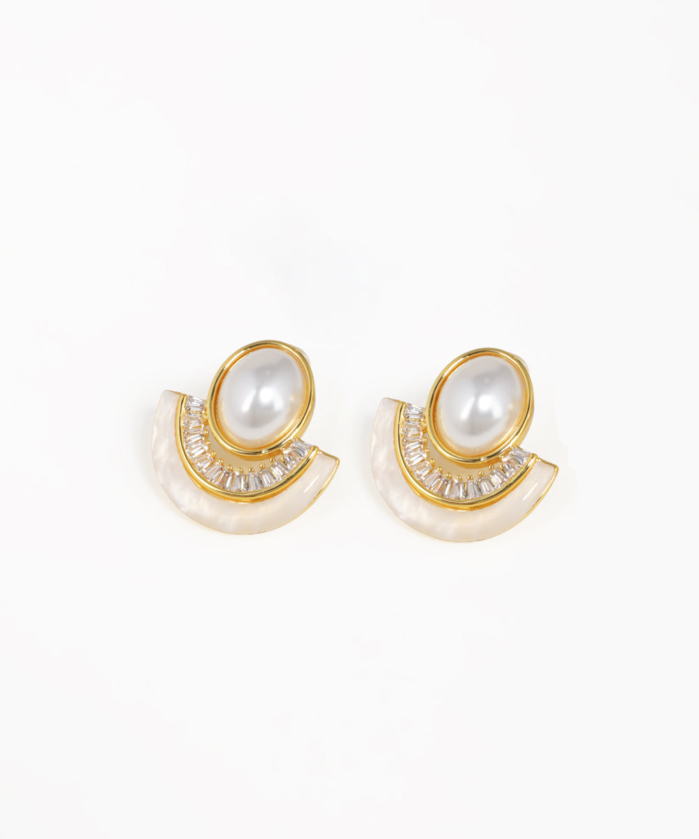 Pair of earrings with pearl-like stones and gold accents on a white background