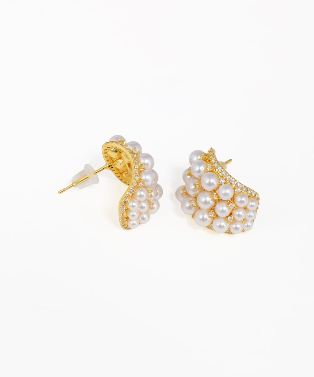 Gold crescent stud earrings featuring clustered pearls and sparkling stones