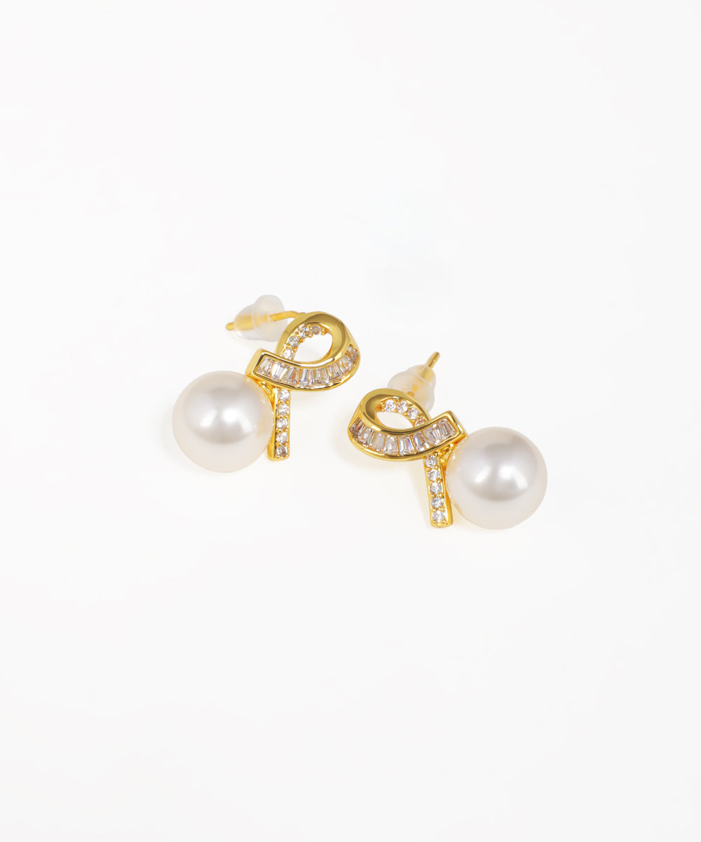 Gold knot stud earrings featuring elegant drop detailing