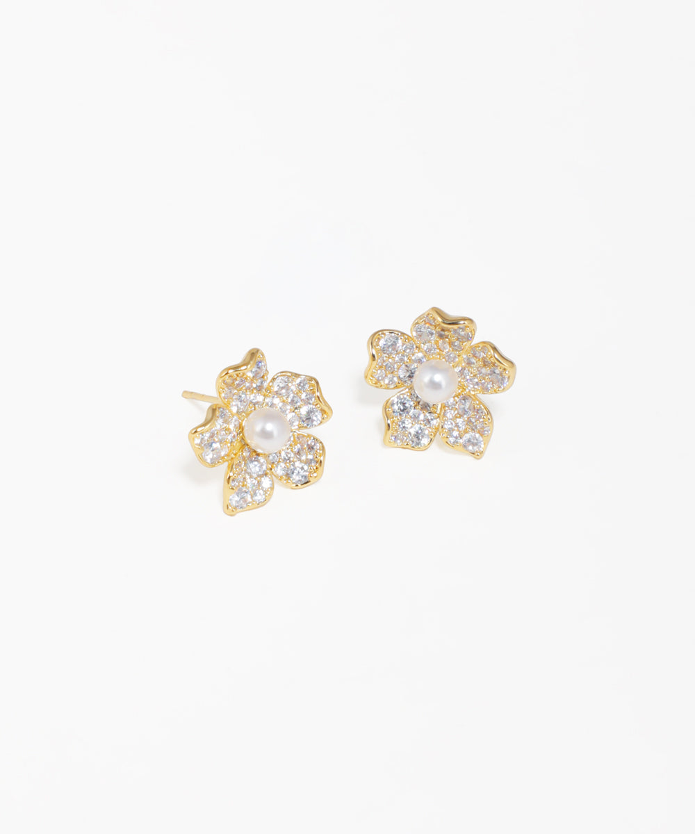 Flower motif stud earrings with pearl center and gold-tone finish