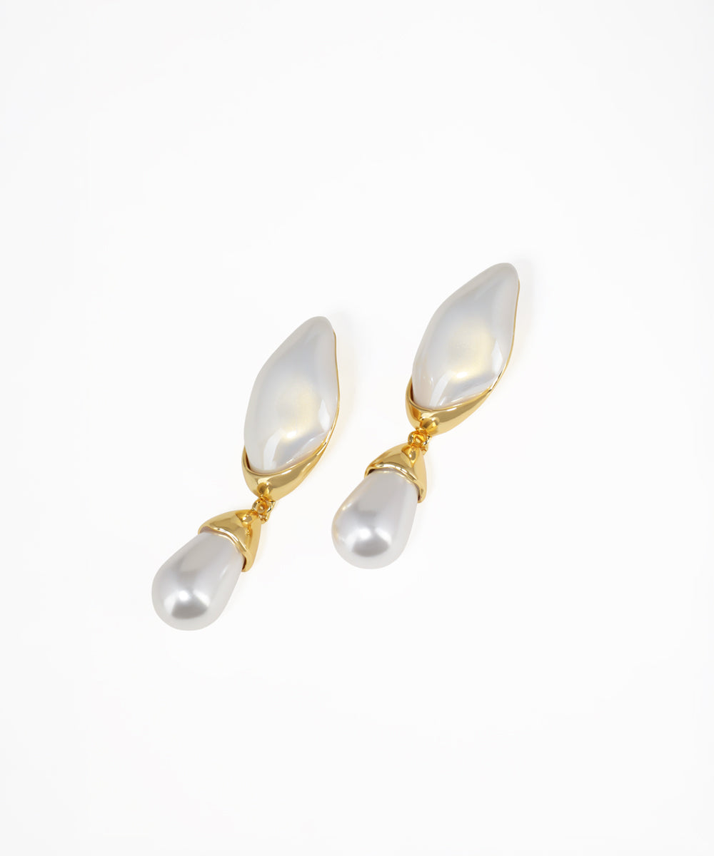 Pair of pearl earrings with gold accents on a white background