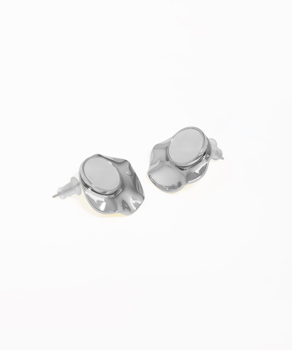 Contemporary stud earrings featuring abstract disc and oval shapes