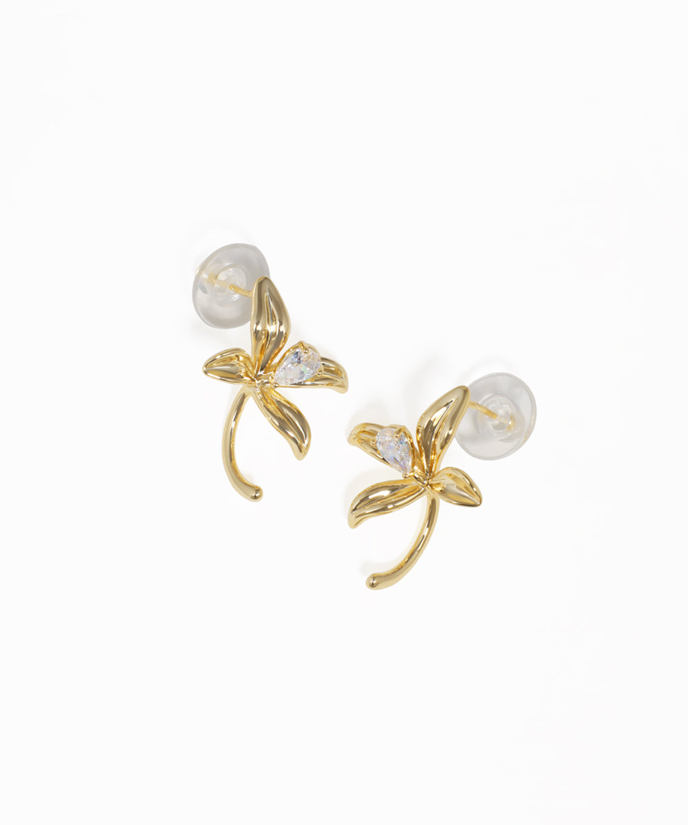 Gold floral drop earrings featuring curved petal design and crystal accents