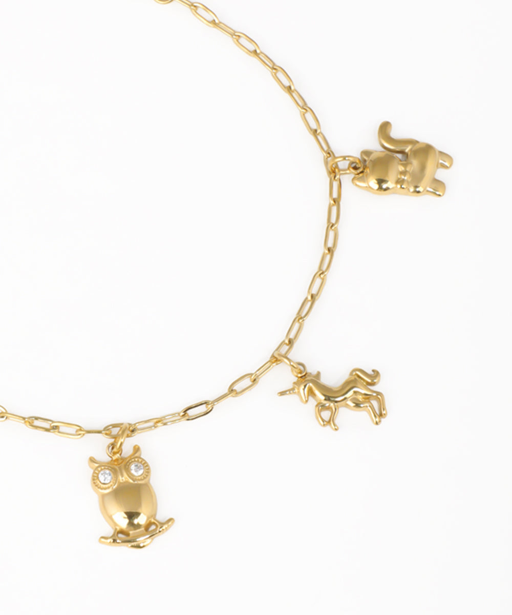 Gold charm bracelet with owl, unicorn, cat and animal-themed dangling charms