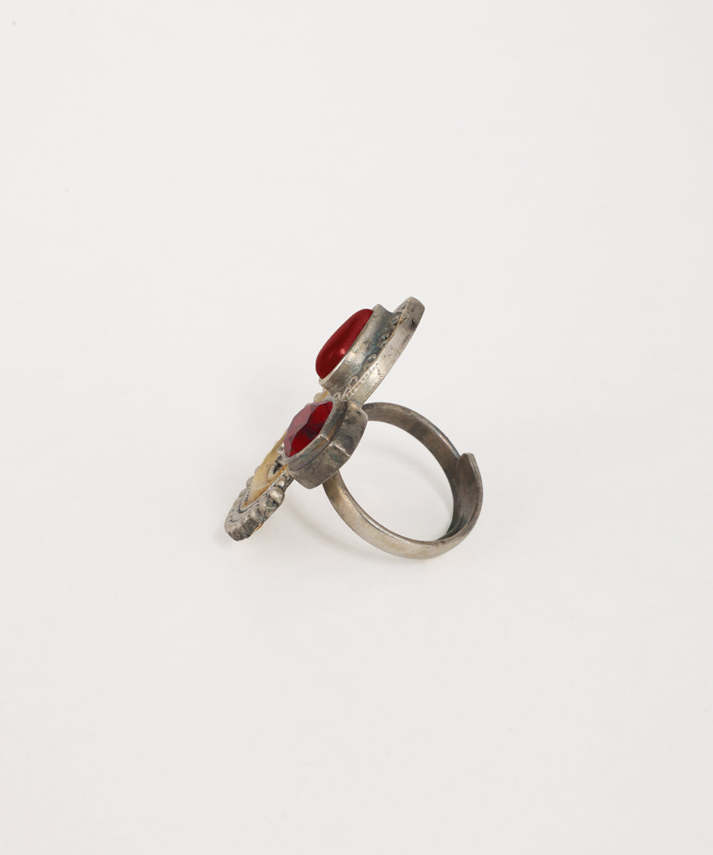Silver ring with red stones on a white background