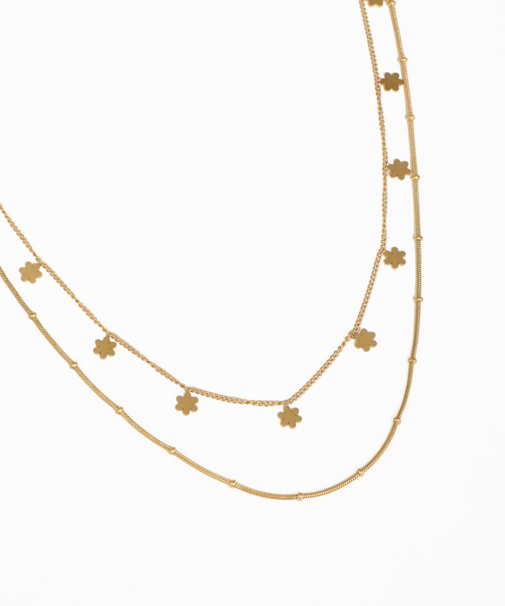 Delicate layered floral charm necklace for women with gold-tone chains
