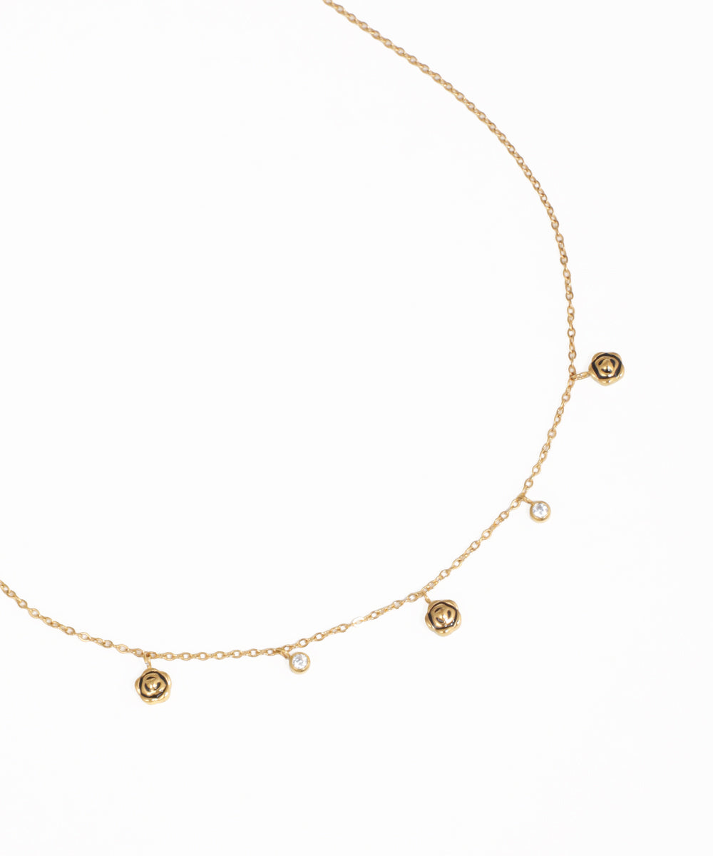 Dainty charm necklace with crystal stone details and delicate gold-tone chain