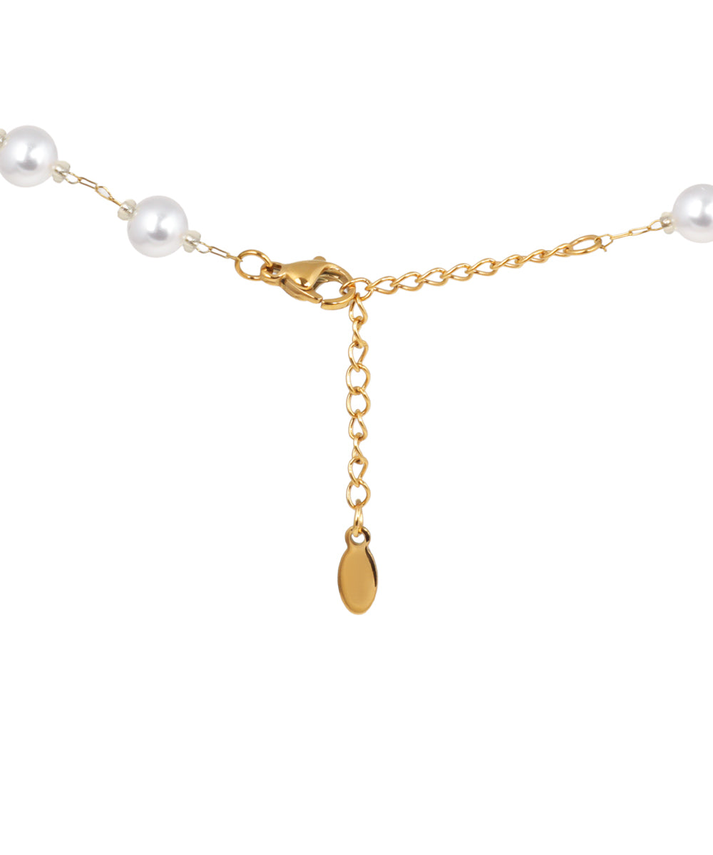 Minimal gold necklace featuring evenly spaced bead details