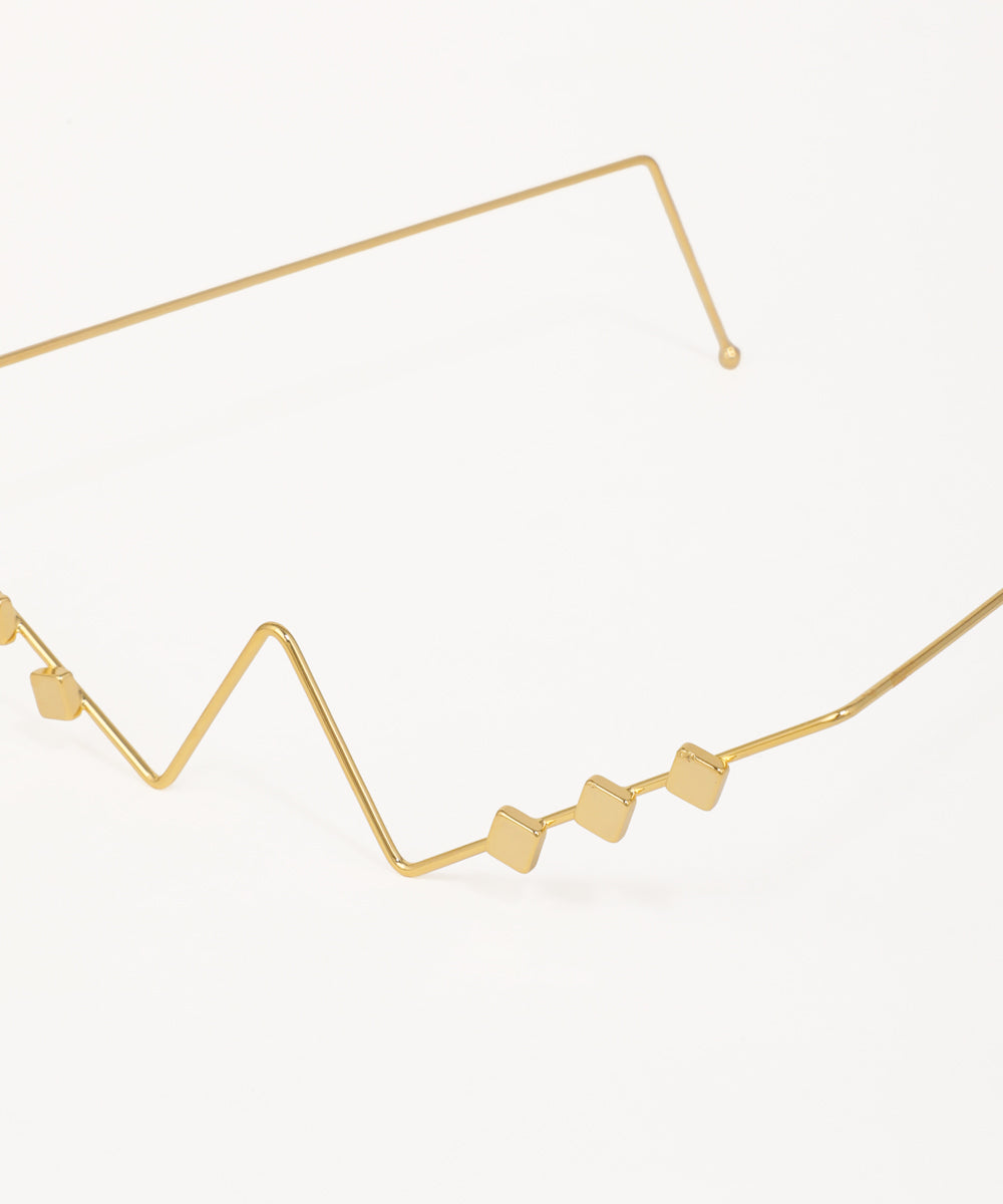 Modern geometric facelet with minimalist gold wire construction and cube accents