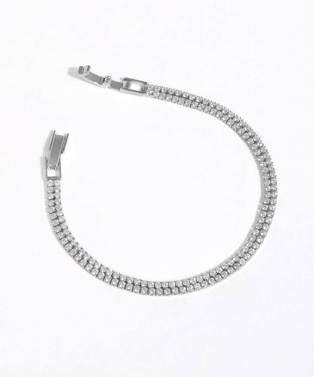 Silver bracelet with clear stones on a white background