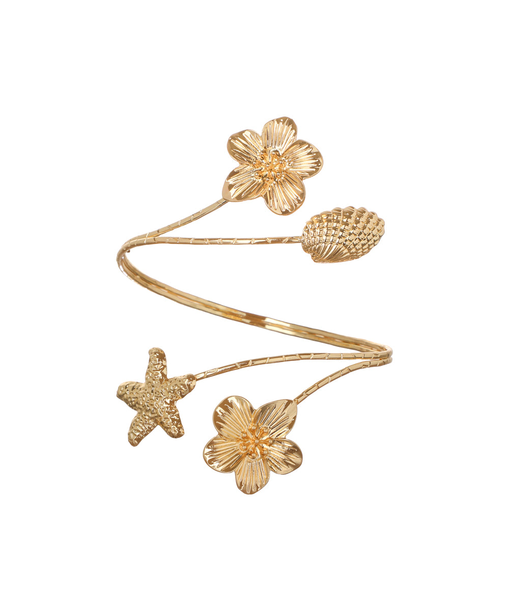 Gold finish arm cuff with sculpted floral, starfish, and pod motifs on a wrap-around band