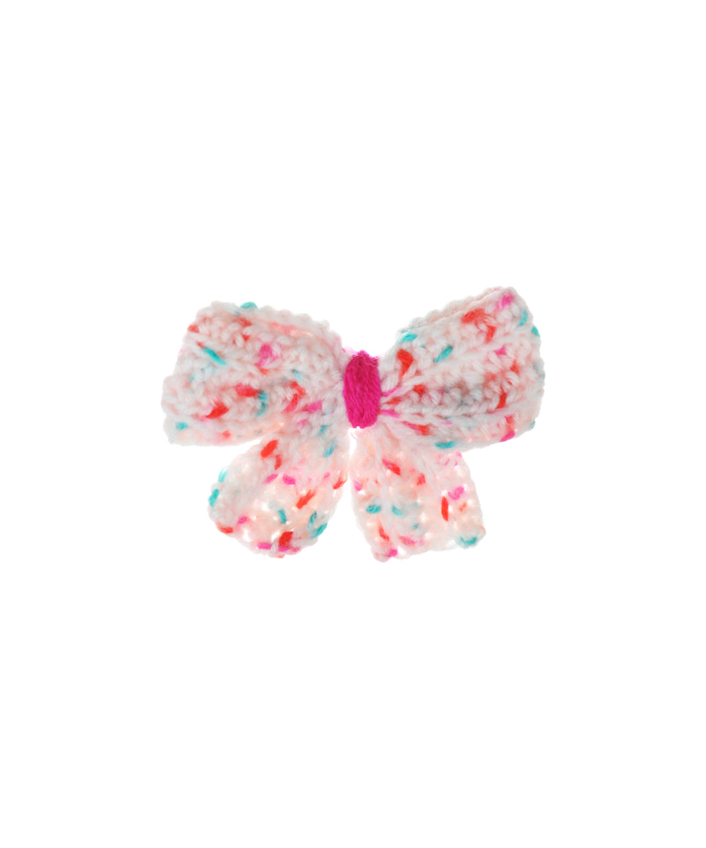 Pastel crochet hair clip with speckled confetti pattern and fuchsia center