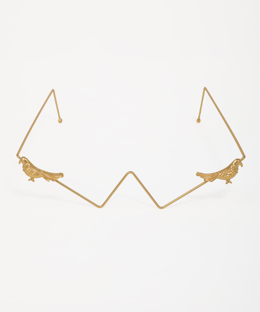 Gold-tone facelet with detailed bird motifs and geometric wire frame