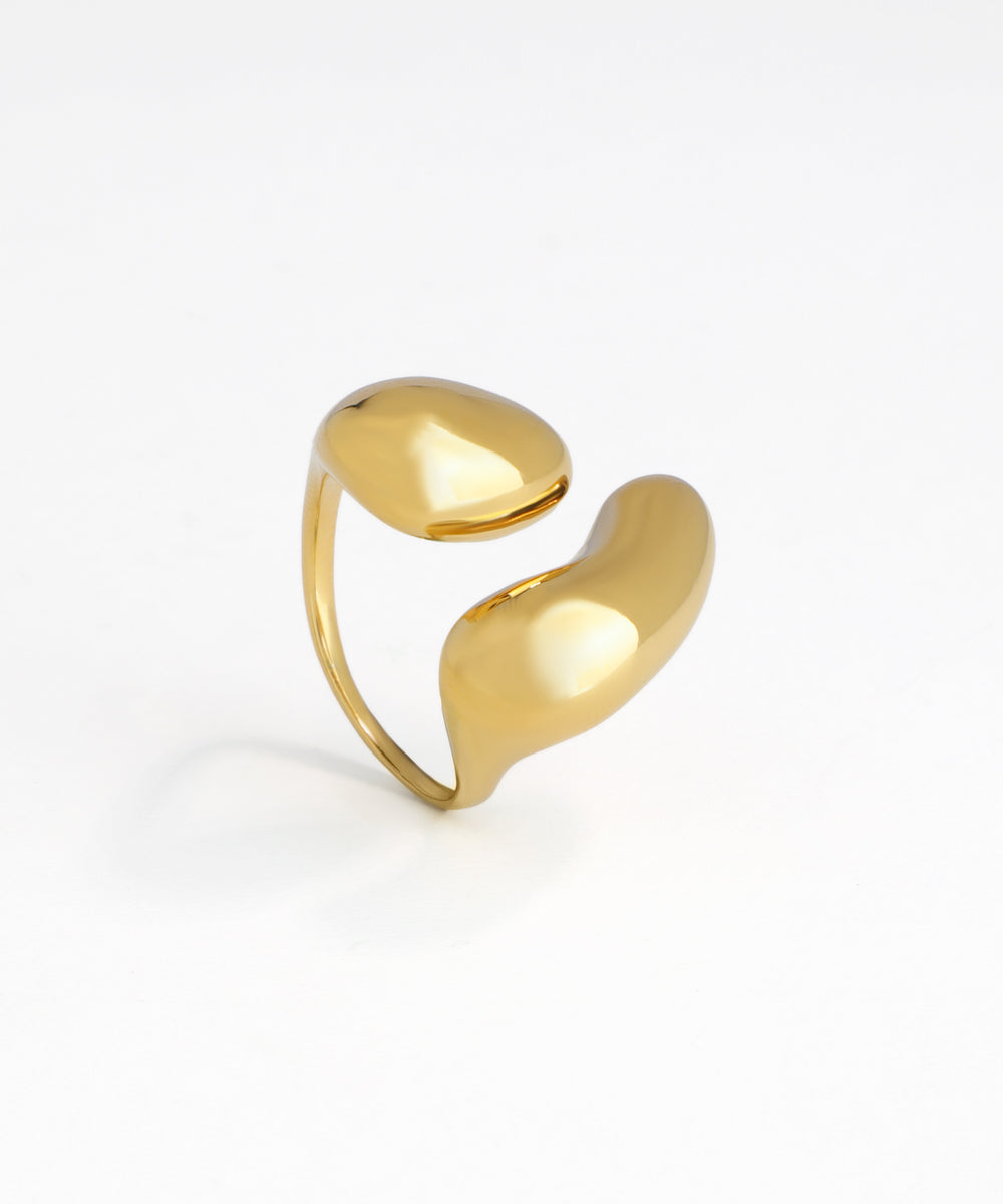 Gold-tone ring featuring two polished, abstract fluid forms on an open band.