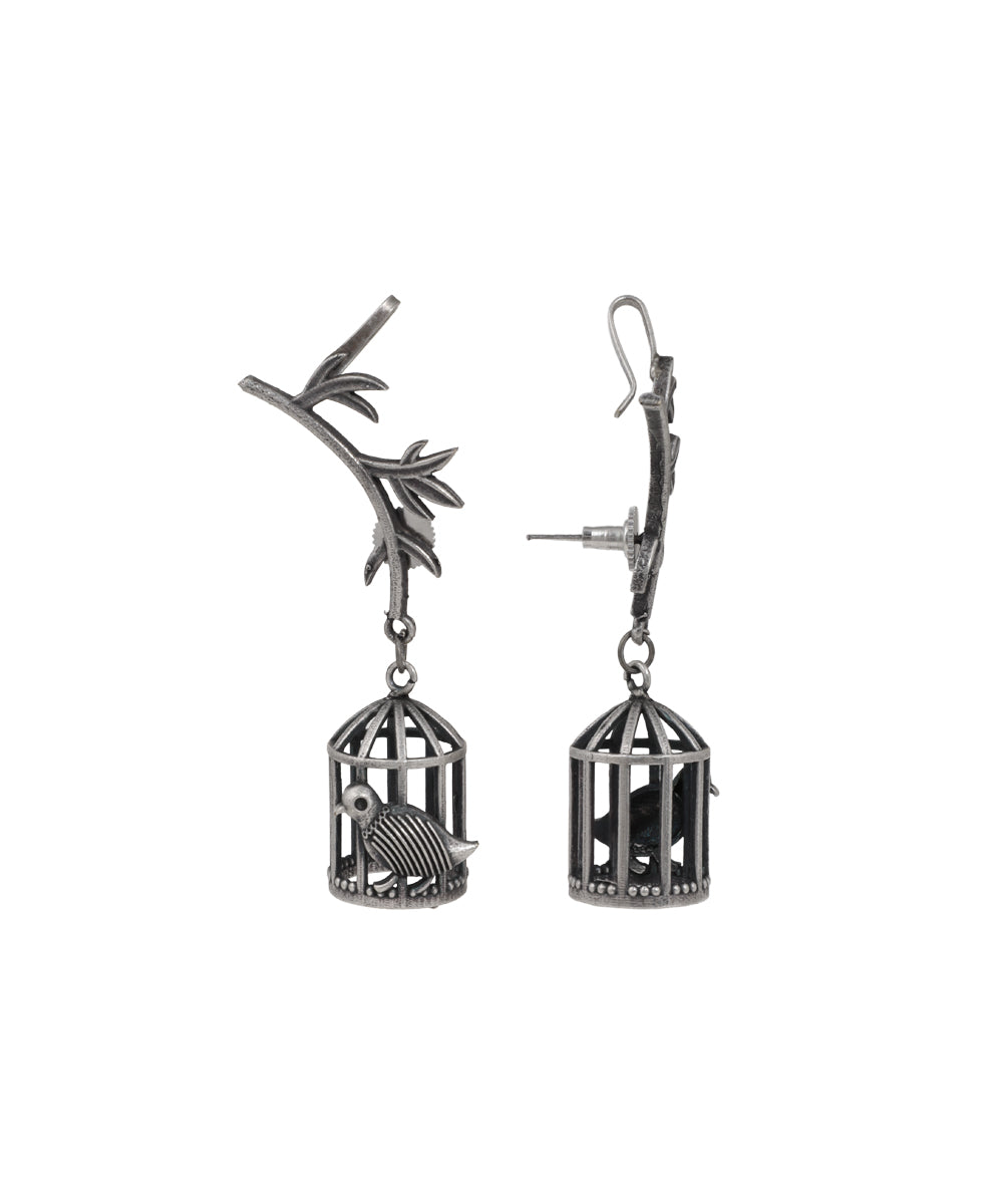 Oxidised drop earrings with a branch motif and dangling birdcage design