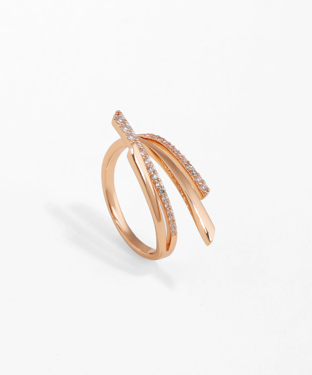 Rose-gold-tone ring with curved, layered crossover bands, some set with clear cubic zirconia stones.