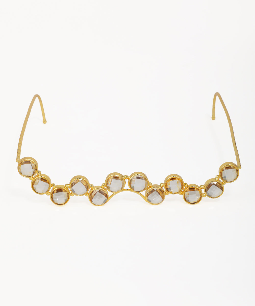 Gold-tone facelet with a wavy line of clear, round, bezel-set details