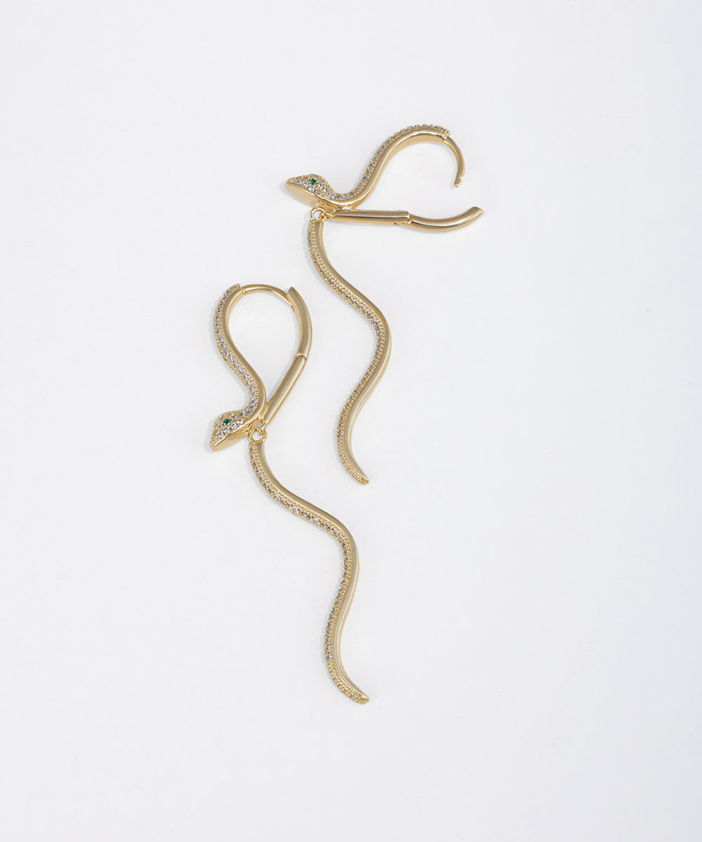Gold-tone dangle earrings with wavy serpent design and sparkling cubic zirconia stones.