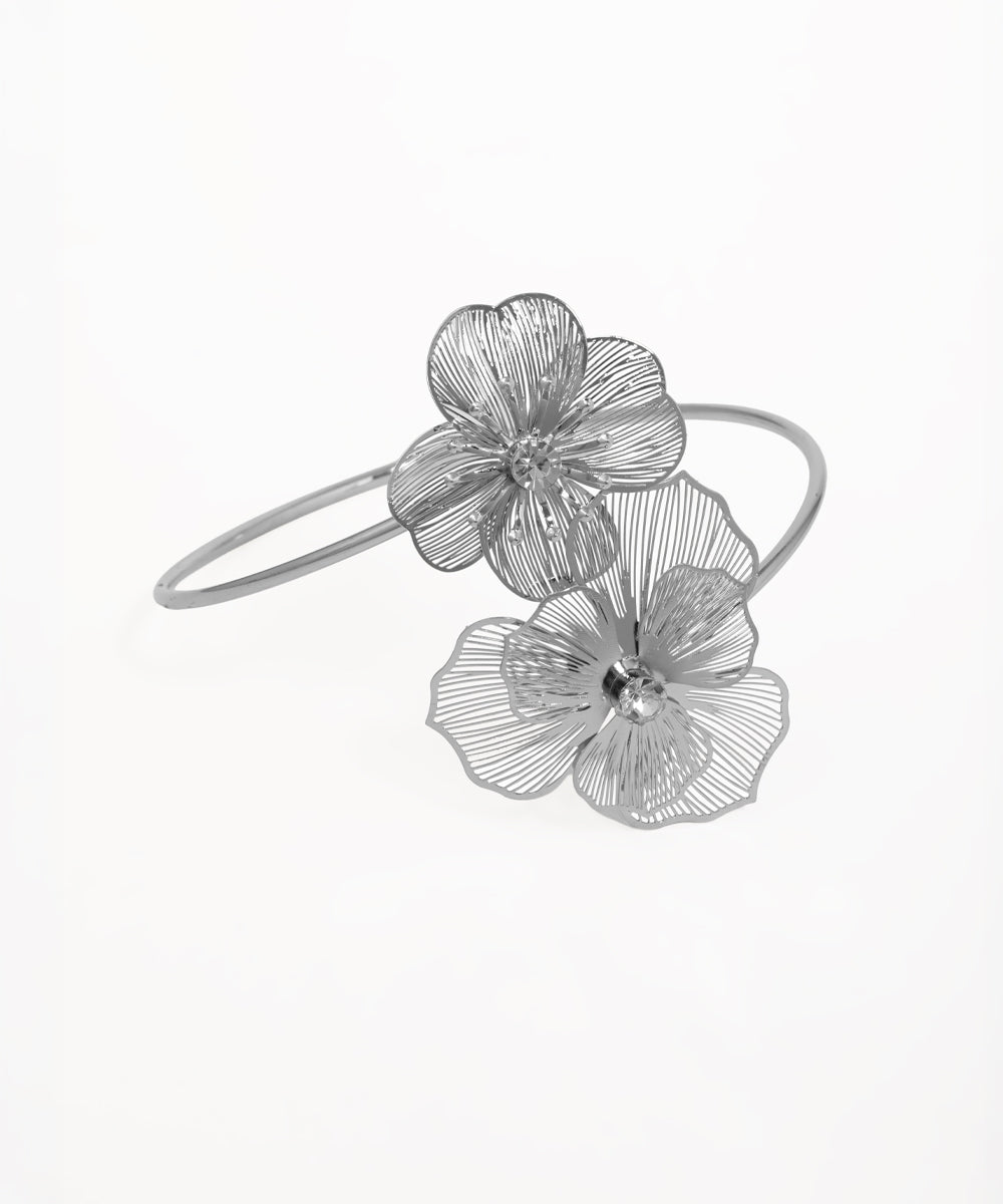Silver-tone arm cuff with two filigree flowers, each featuring a clear center stone