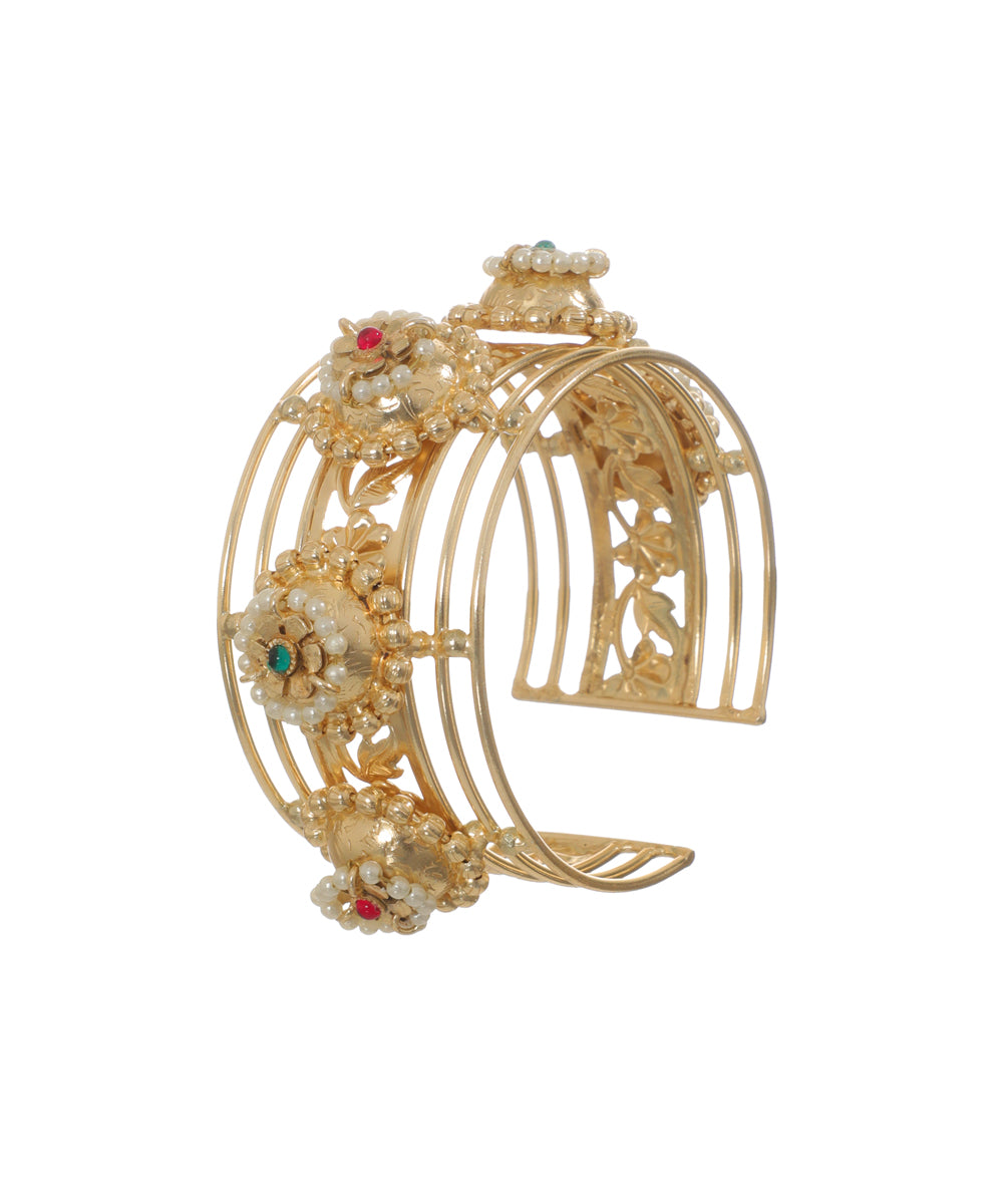 Oxidised cuff bracelet with intricate floral motifs, faux pearls, and colored stones.