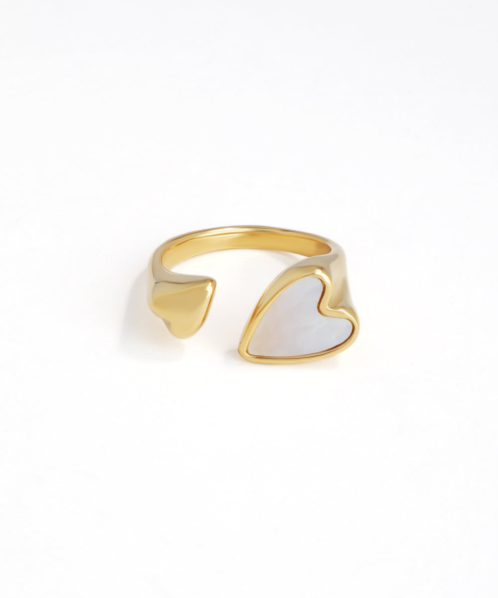 Gold-tone open ring with one polished heart and one pearlescent inlay heart design.
