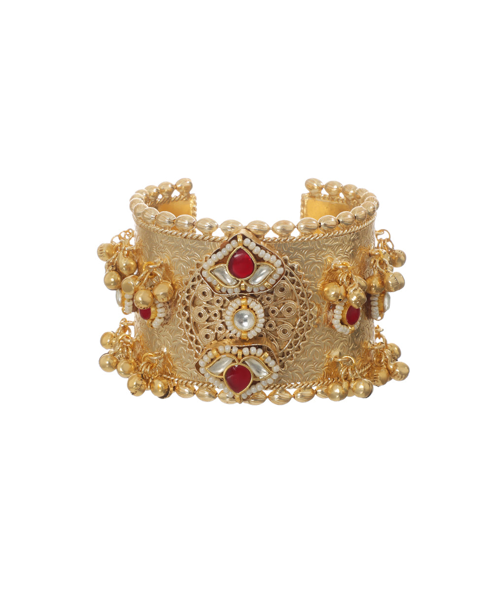 Oxidised gold-tone cuff bracelet with red and white stones and small jhumka drops