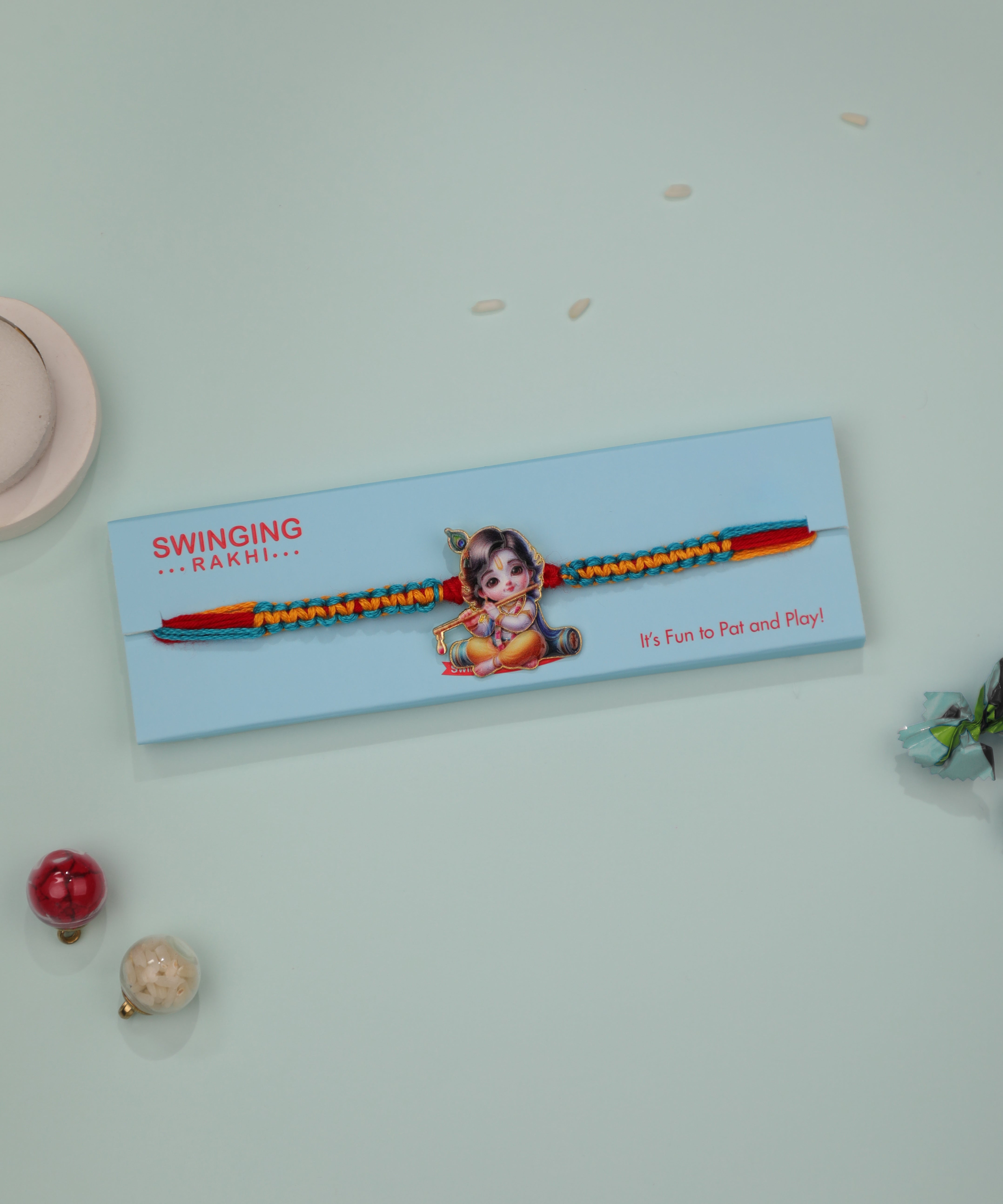Multicolour braided thread Rakhi with cute Bala Krishna printed charm