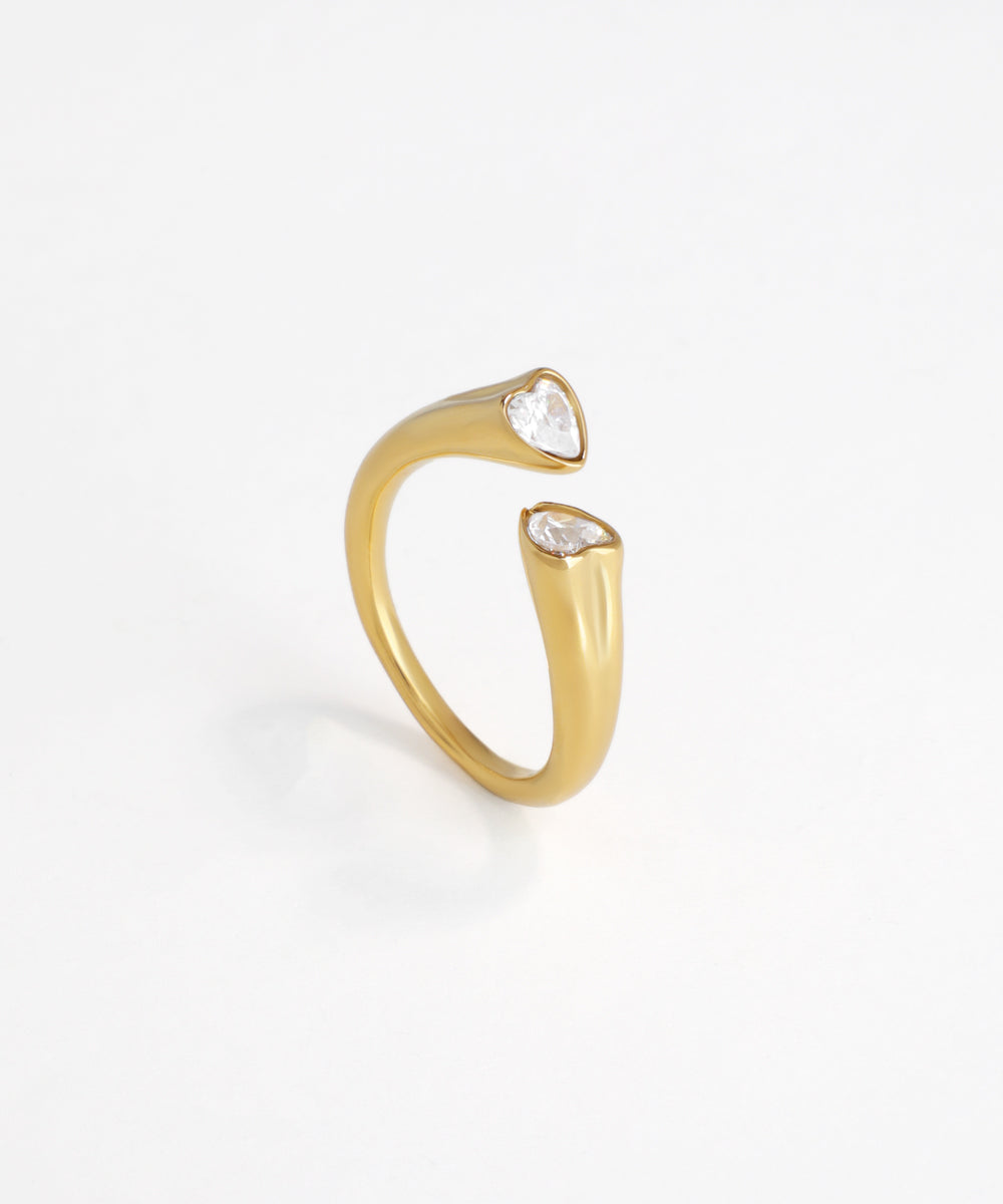 Gold-tone open ring with two heart-shaped cubic zirconia stones at each end