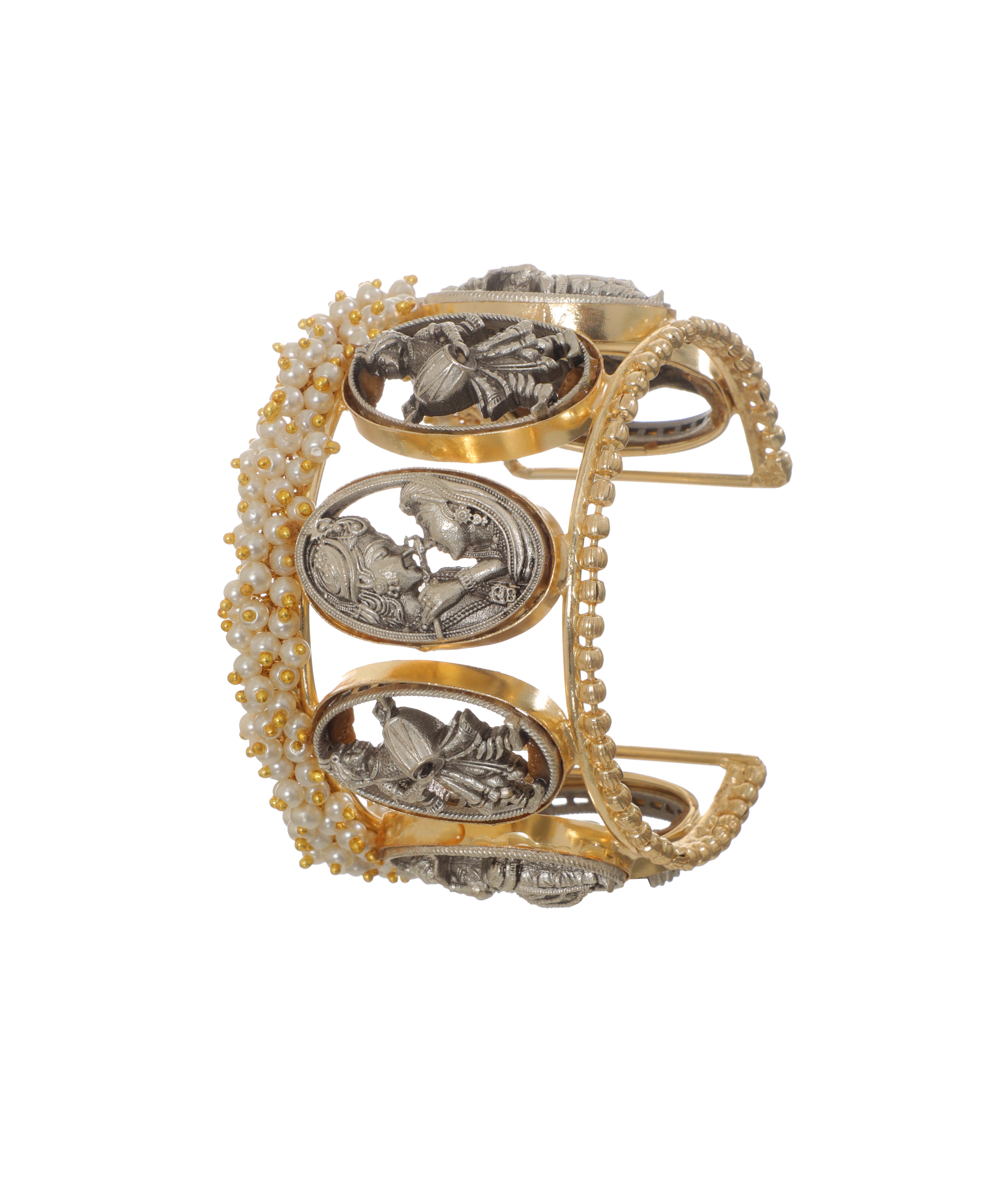 Gold-tone and oxidized cuff bracelet with traditional figurines and faux pearls