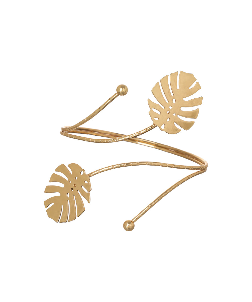 Gold-tone arm cuff with spiral design and two monstera leaf accents