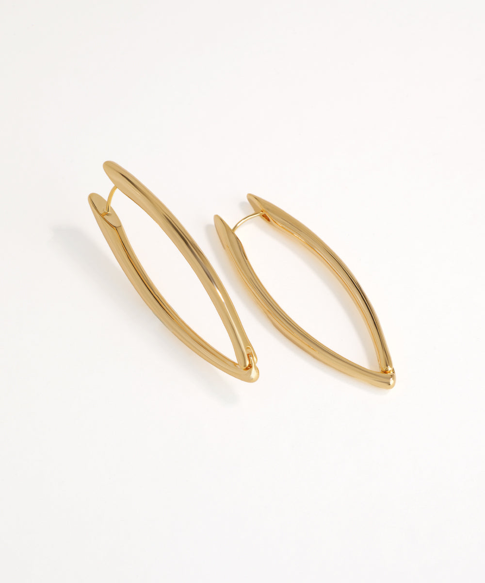 Gold hoop oval earrings on a white background