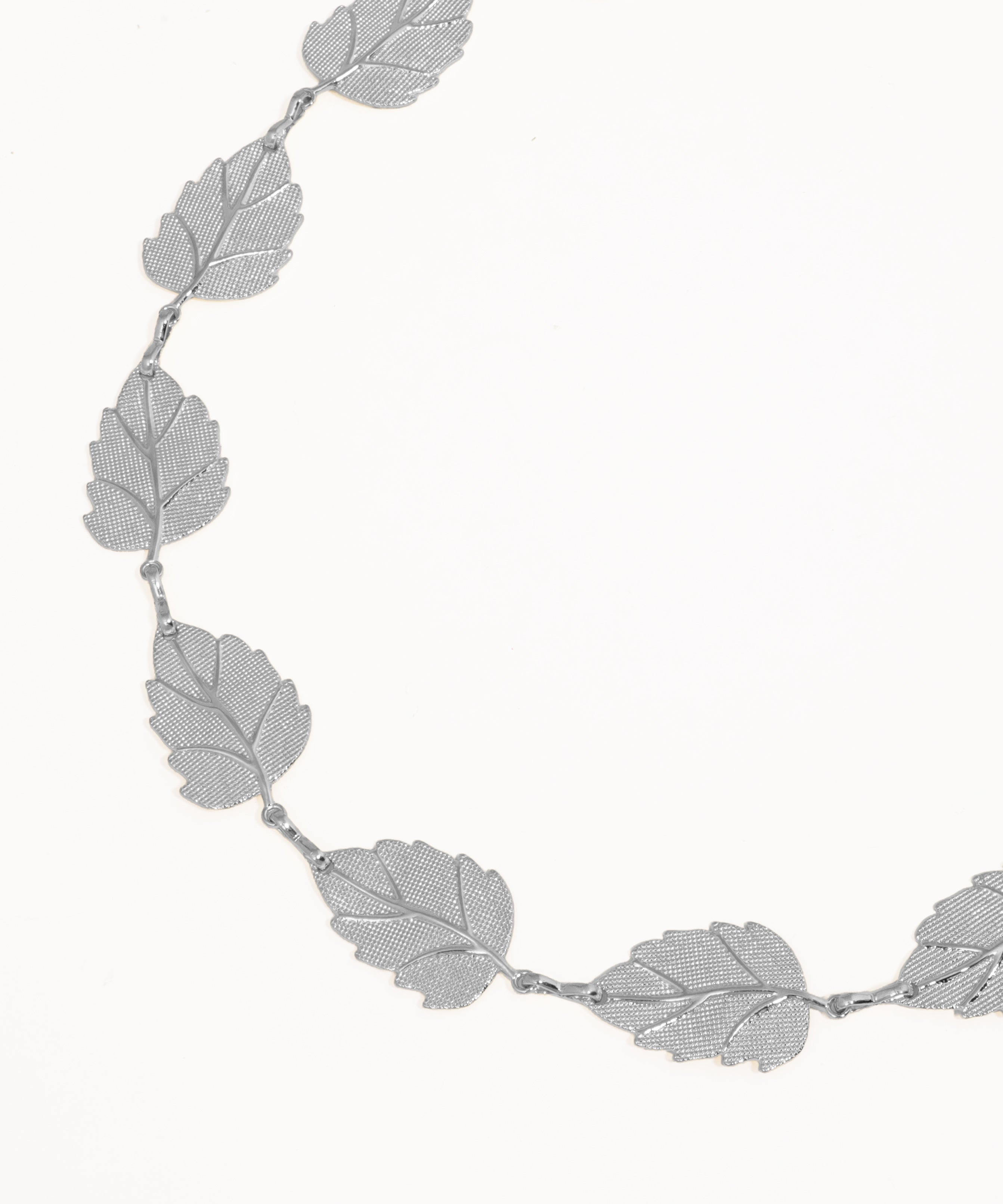 Silver leaf-shaped necklace on a white background