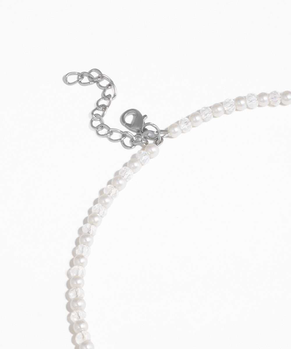 Close-up of a pearl necklace with clasp on a white background