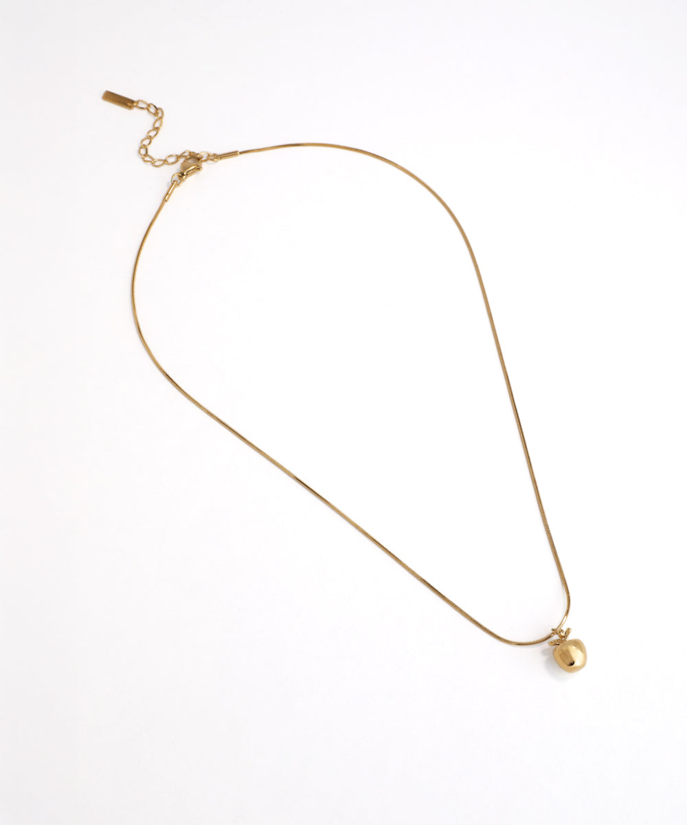 Gold necklace with a pearl pendant on a white background
