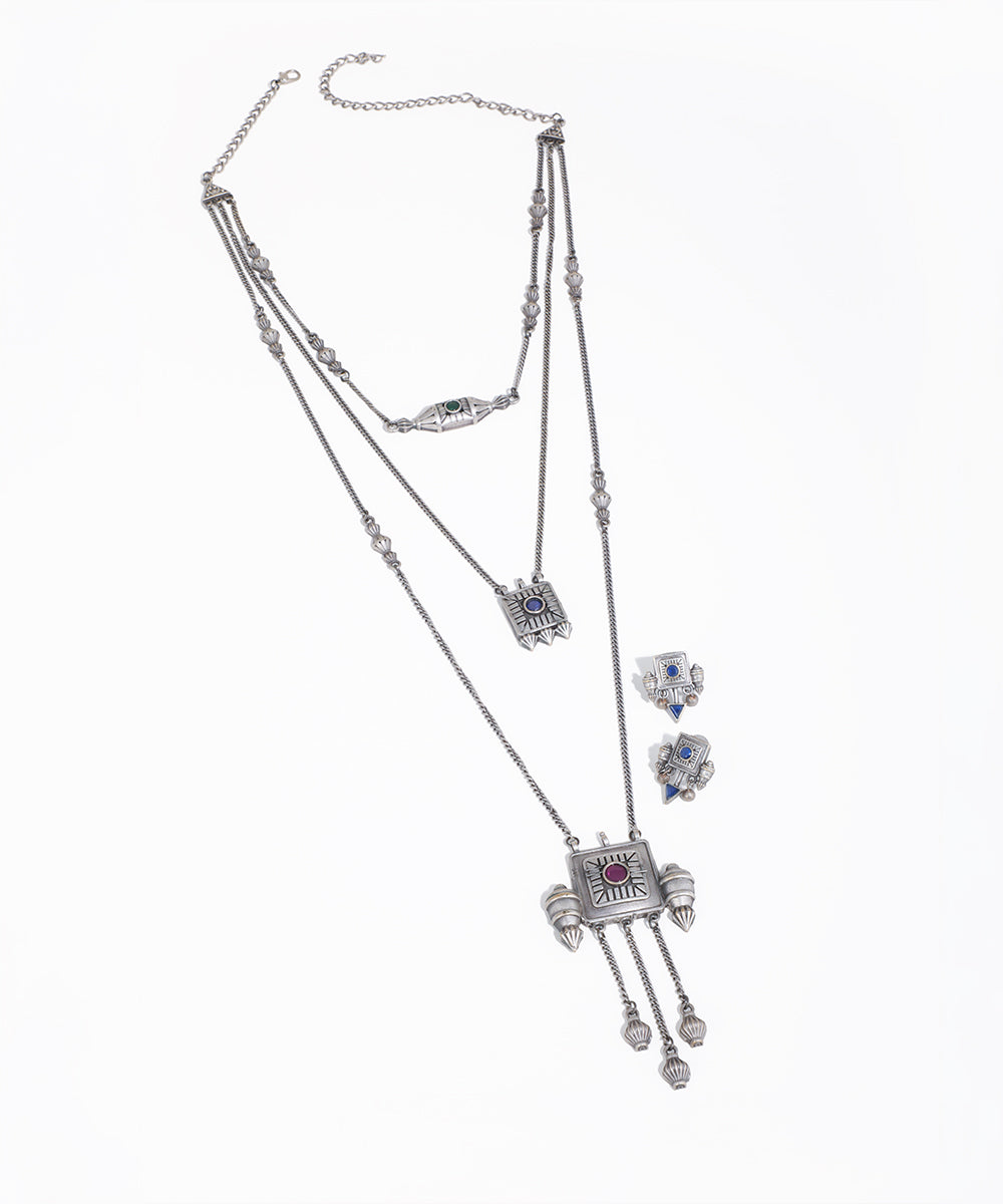 Silver jewelry set with necklace and earrings on a white background