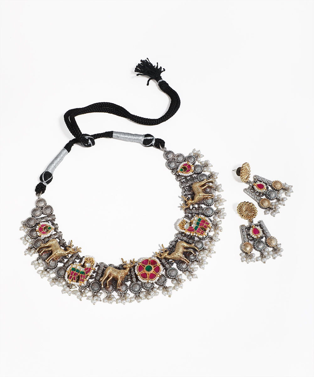 Oxidised necklace set with gold-tone deer motifs, red and green stones, and faux pearls