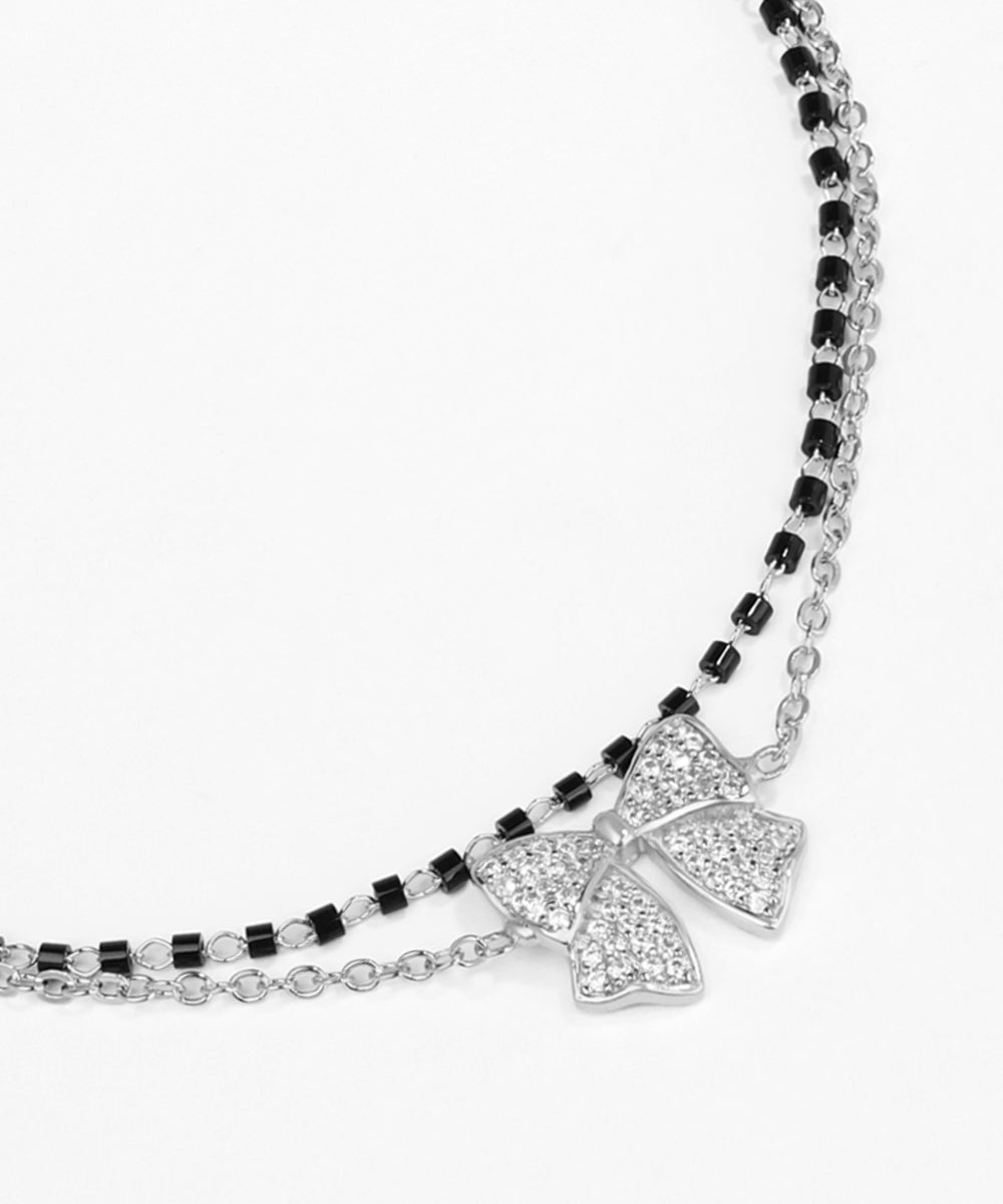 Necklace with a bow-shaped pendant on a white background