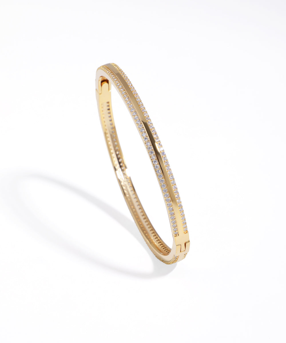 Gold-tone bracelet featuring two parallel rows of sparkling cubic zirconia