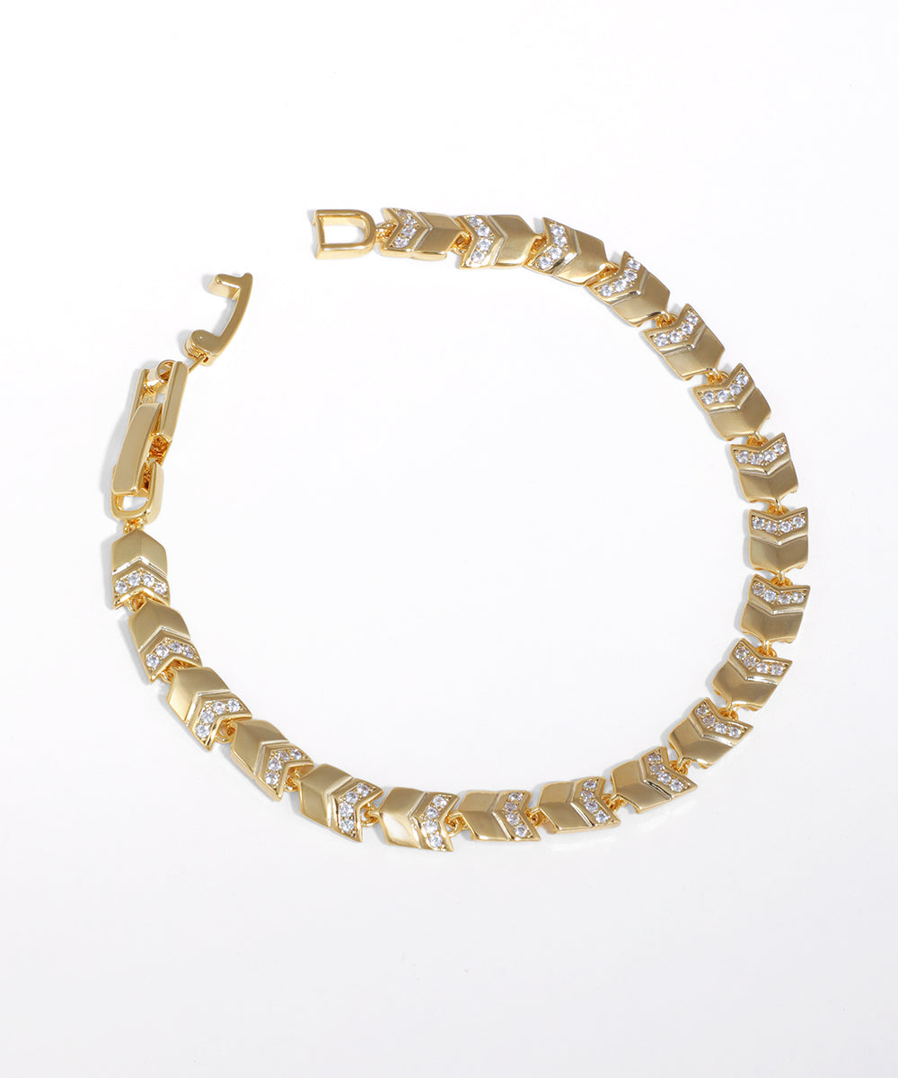 Gold-tone chevron link bracelet with clear CZ accents and a box clasp closure