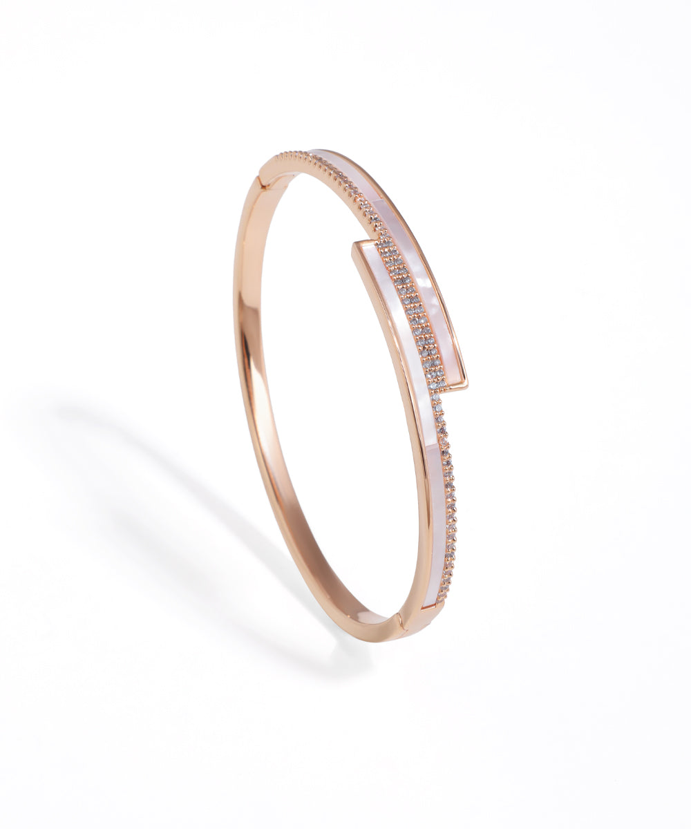 Rose gold bracelet with diamond accents on a white background