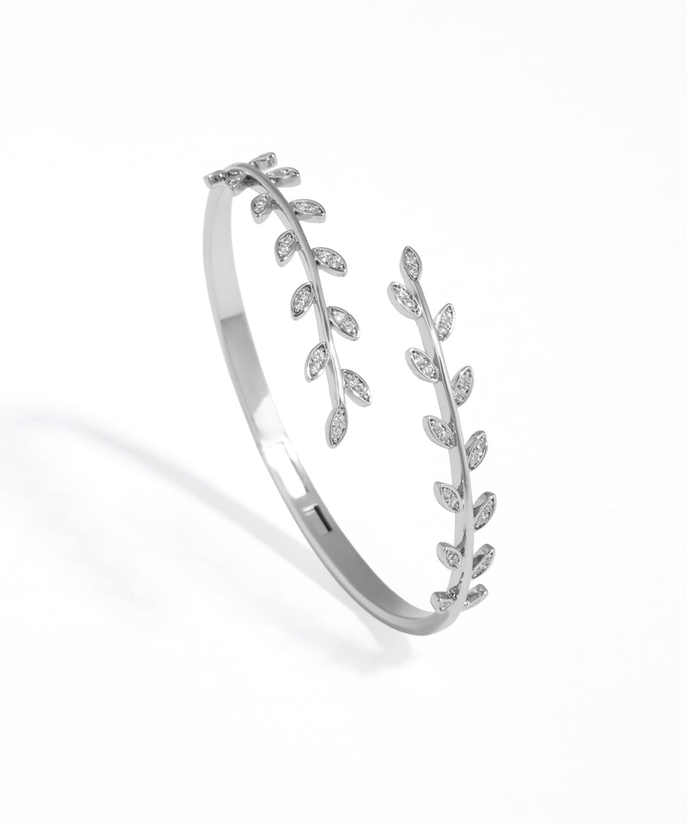 Silver bracelet with leaf design on a white background