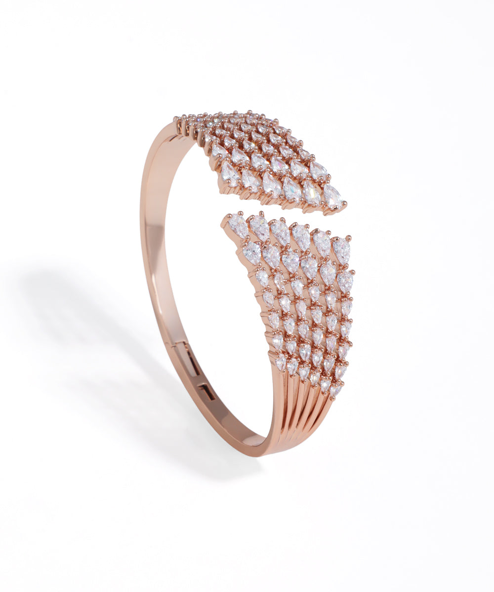 Rose gold bracelet with diamond accents on a white background