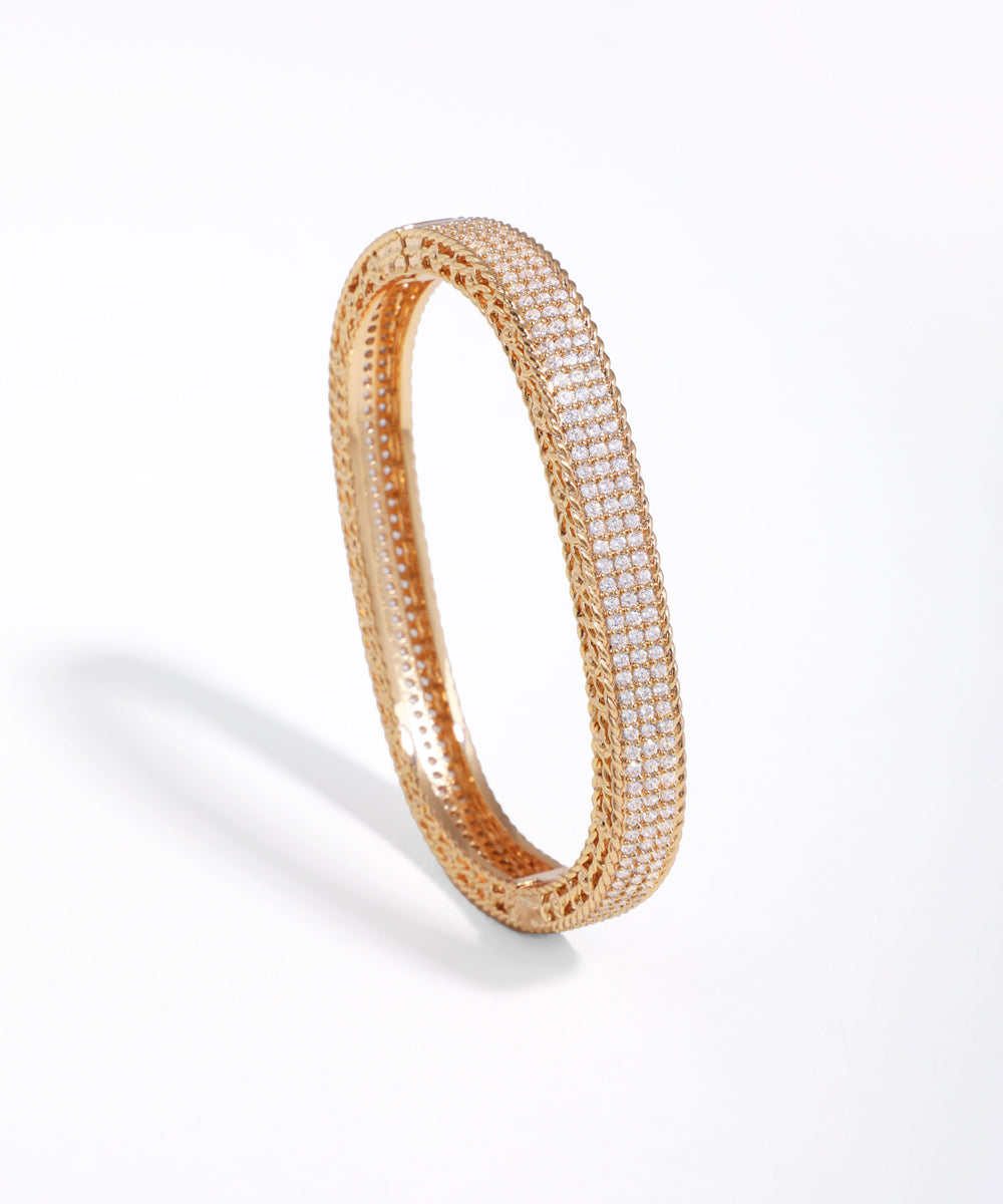 Gold-tone bracelet with pavé-set CZ stones and intricate textured metalwork