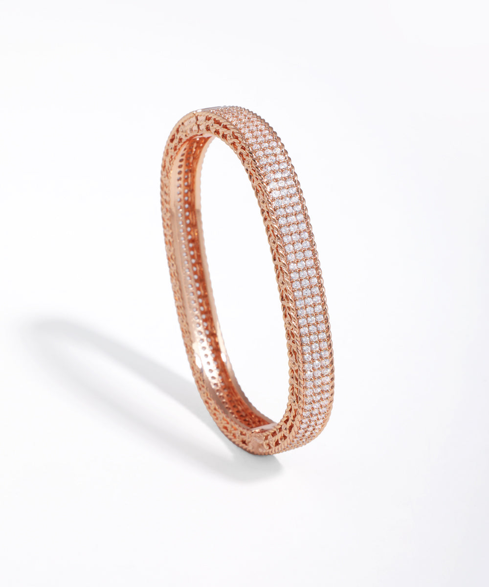 Rose gold bracelet with clear stones on a white background