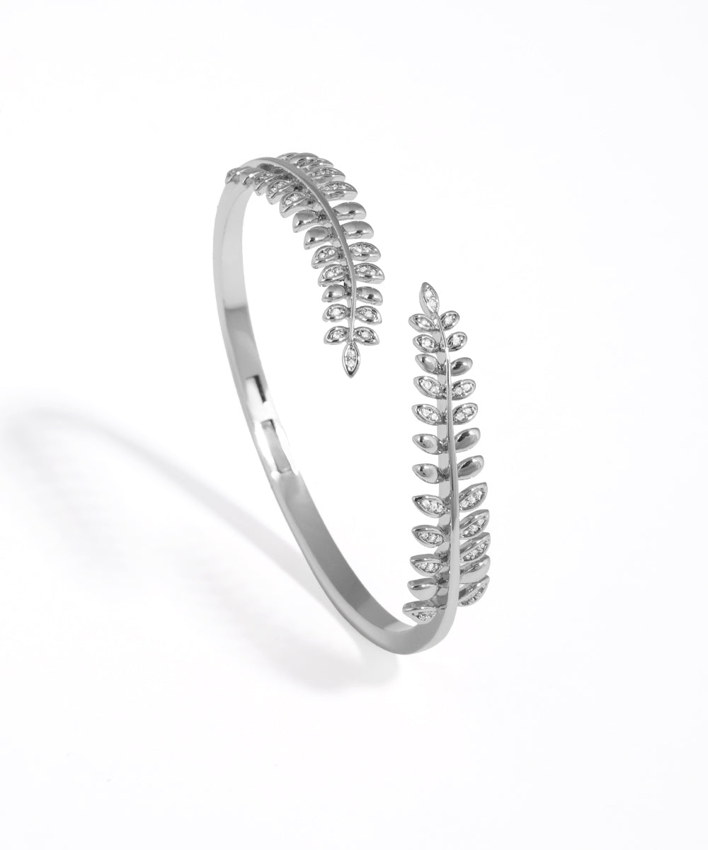 Silver bracelet with leaf design on a white background