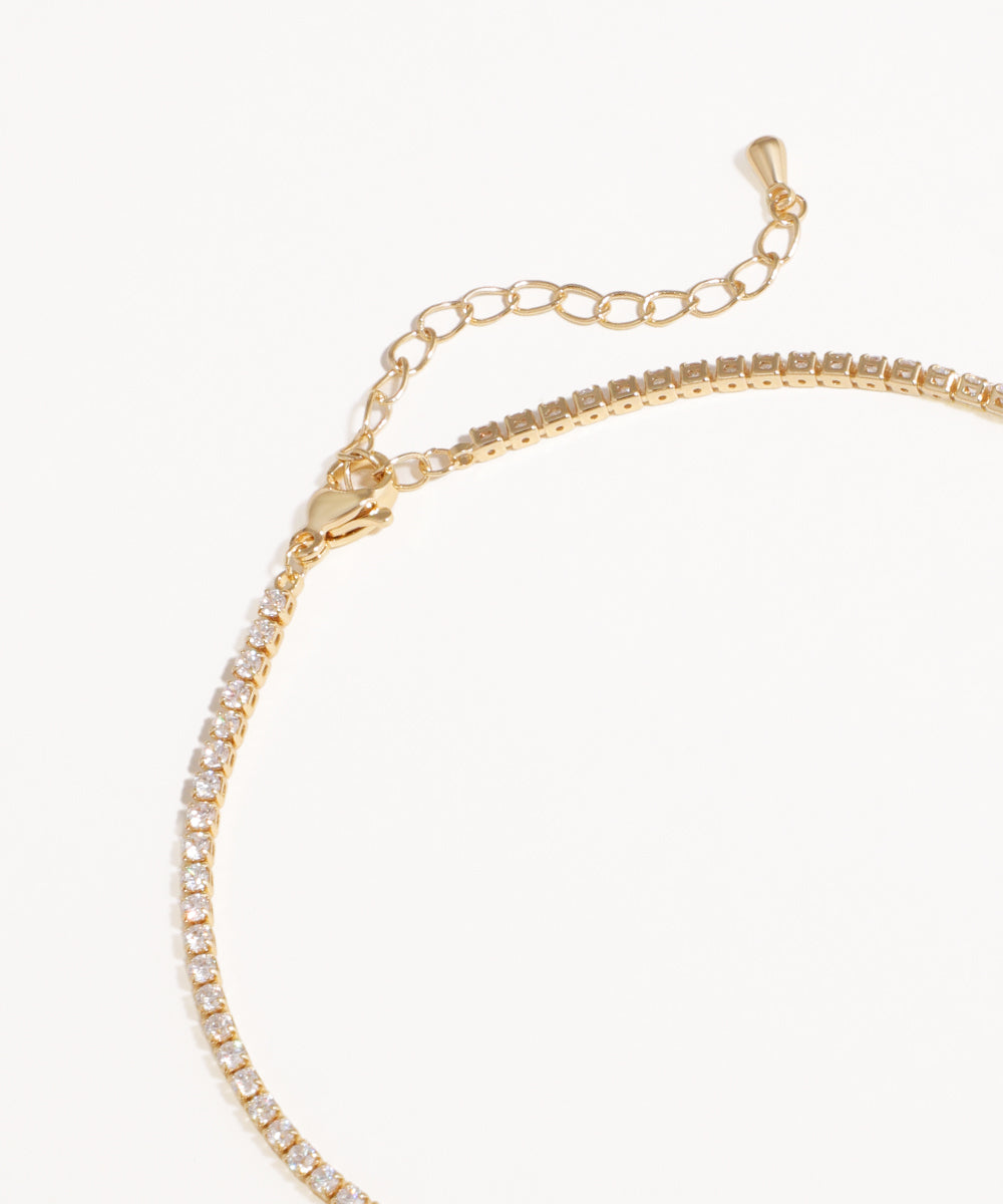 Gold Necklace with clear stones on a white background